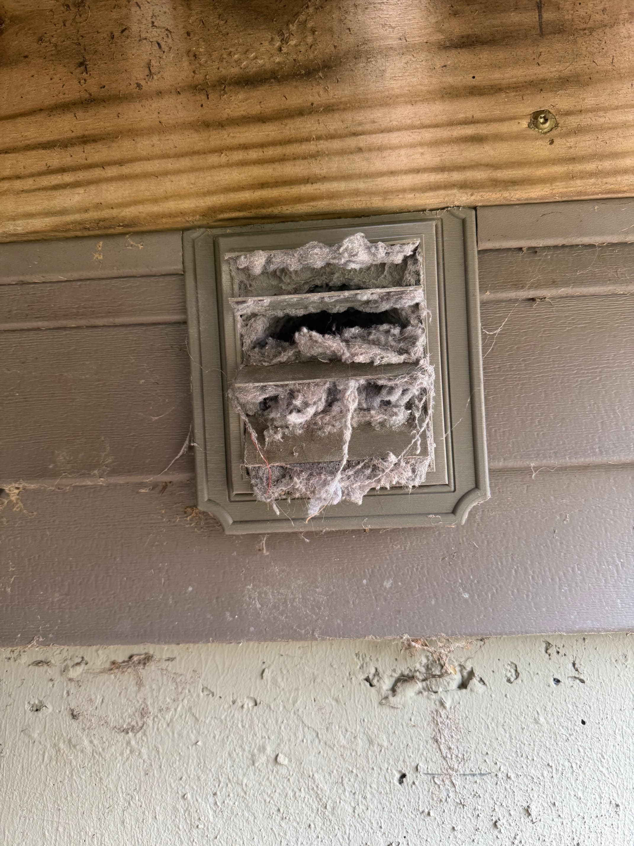 Dryer vent before cleaning with visible lint buildup